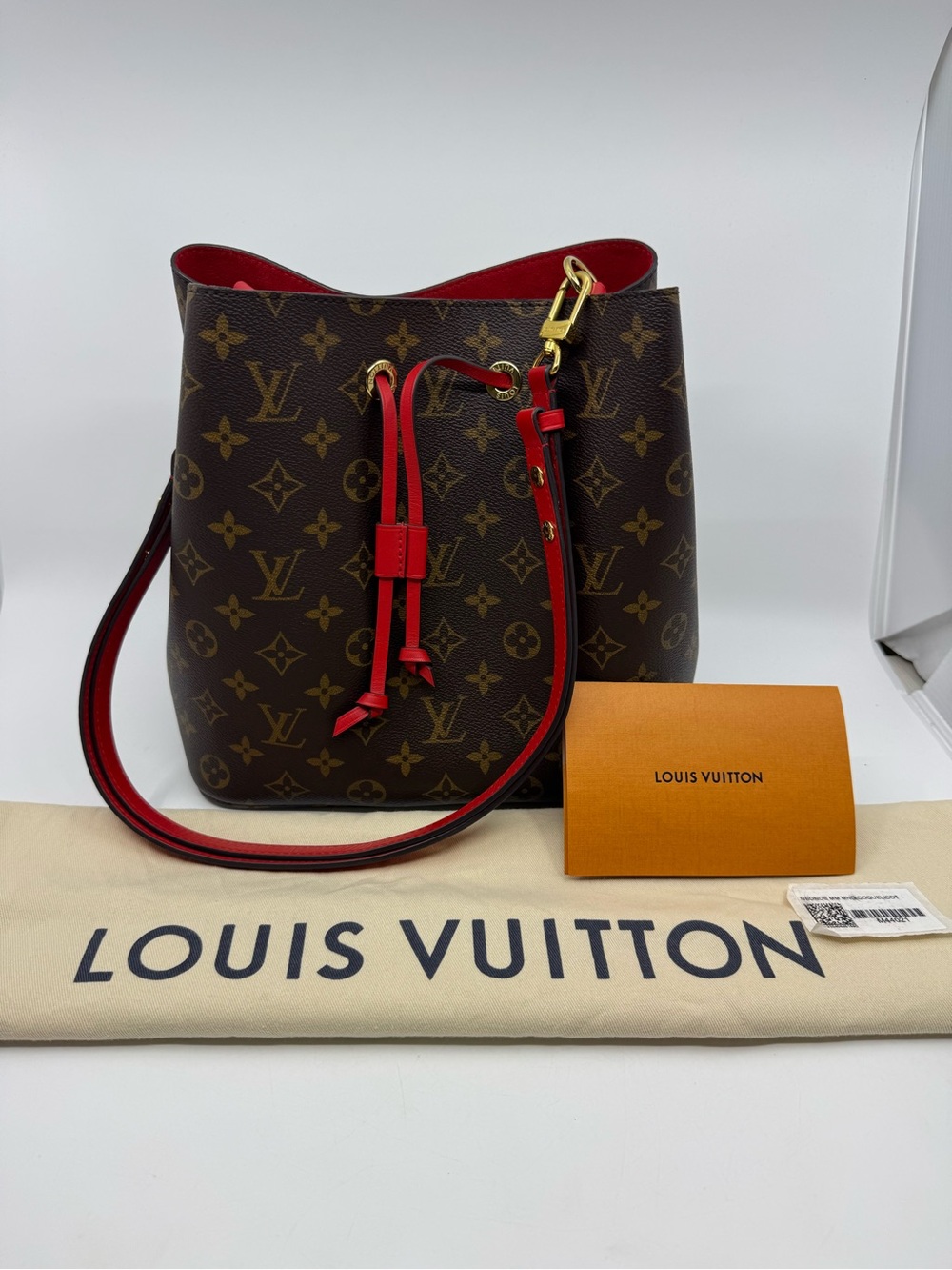 Louis Vuitton NéoNoé MM handbag Monogram canvas with red leather trim.